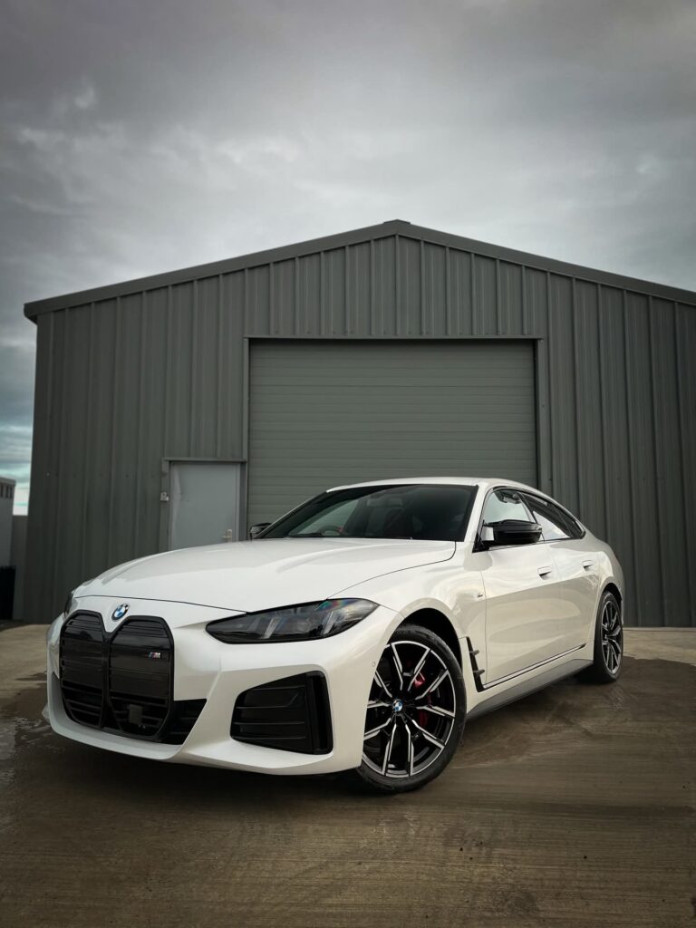 BMW i4 M50 front view in metallic white parked outdoors